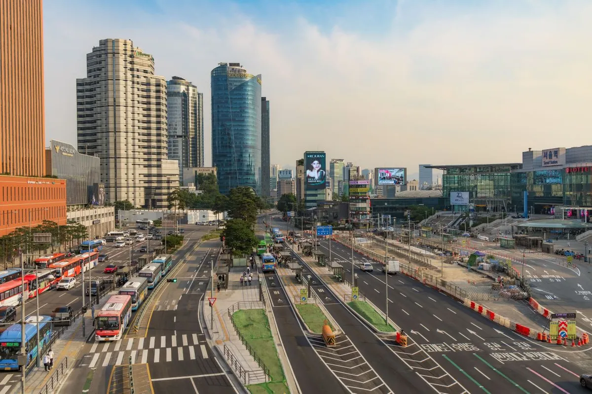 Daytime roads, crossings and station-area buildings around Seoul Station, providing context for a Lotte Mart shopping visit
