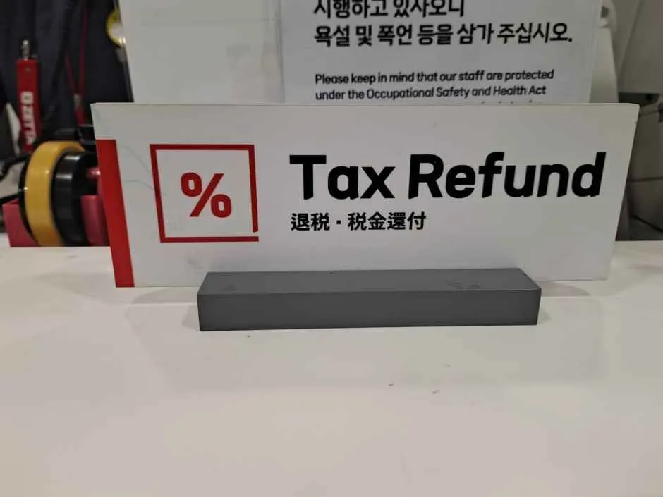 Tax Refund sign with Chinese and Japanese lettering on a countertop in the Seoul Station branch photo gallery
