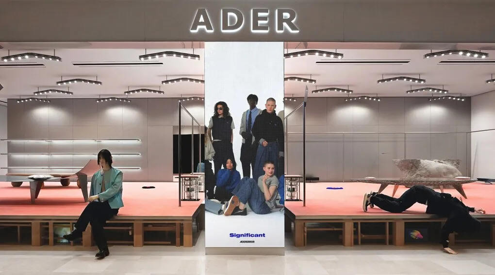 ADERERROR storefront with a pink display platform in Lotte World Mall B1