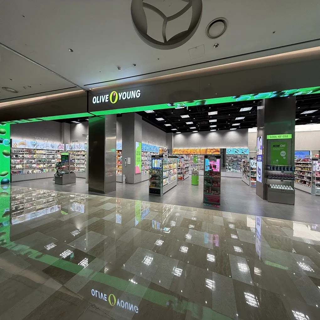 Olive Young storefront and beauty product aisles in Lotte World Mall on the second floor