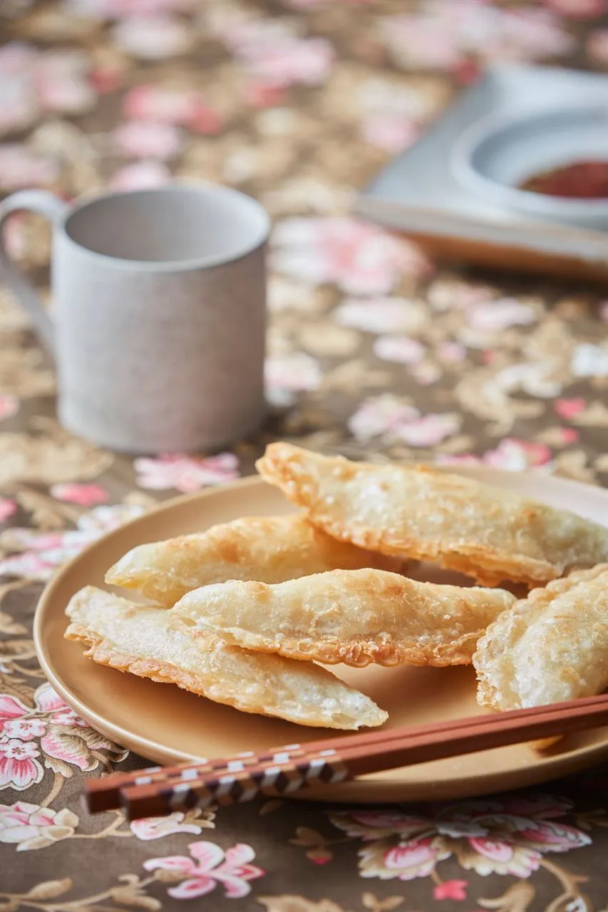 Pan-fried Korean dumplings on a plate for a Korean mandu guide