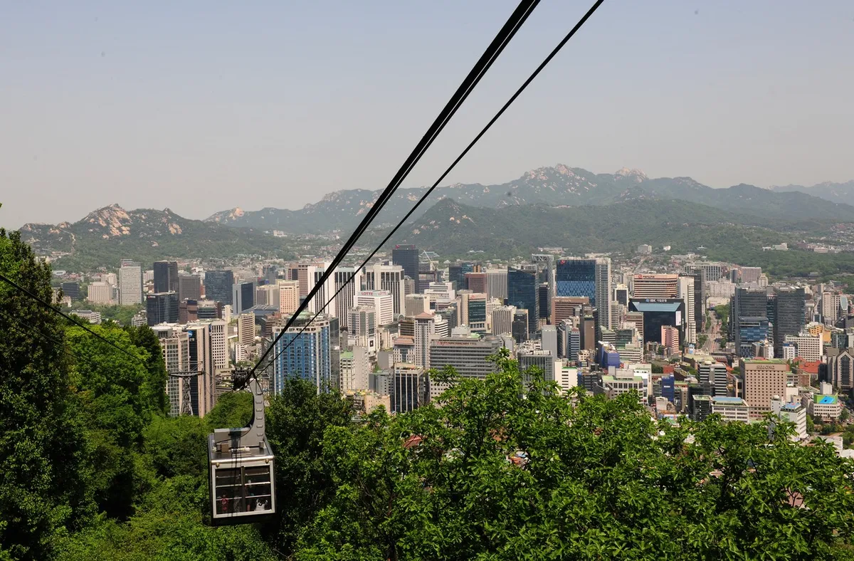 Namsan Cable Car above central Seoul with mountain ridges in the distance
