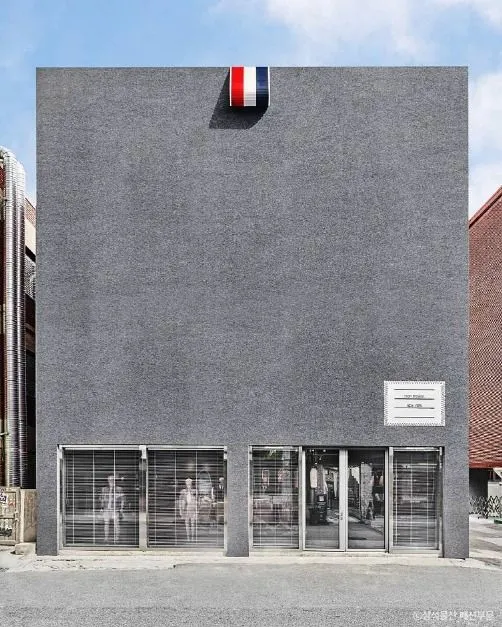 Minimal gray facade of Stage 35 Seongsu on a Seoul shopping street