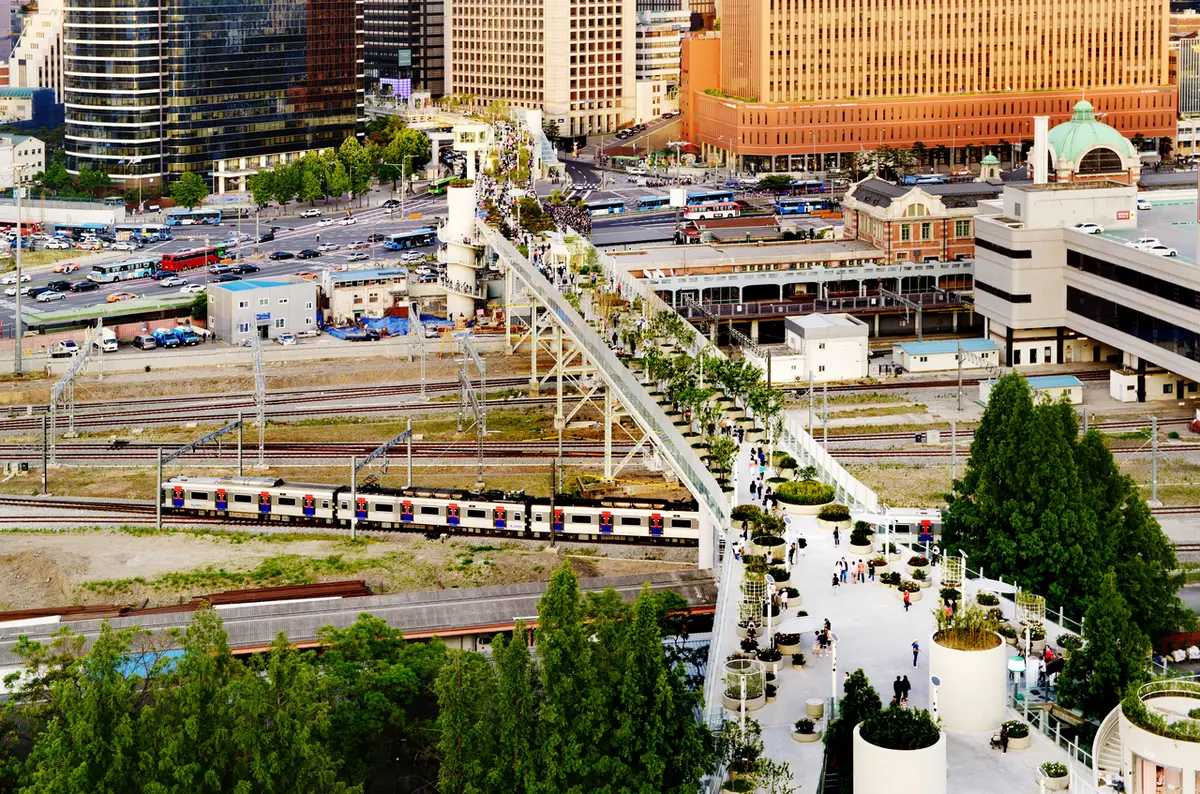 Seoullo 7017 planted pedestrian walkway crossing railway tracks near Seoul Station in daylight