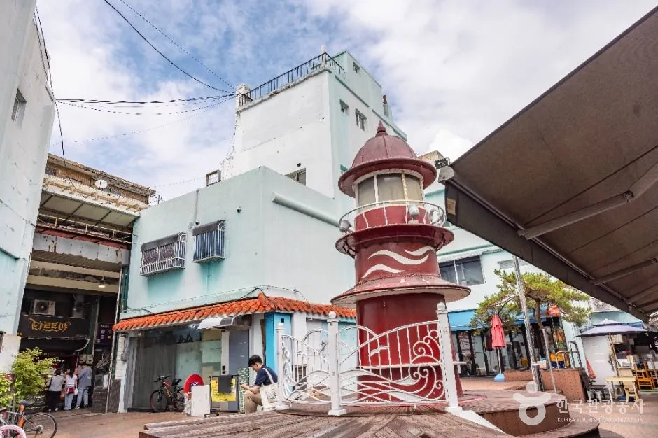 Red lighthouse-shaped landmark beside the Sinpo International Market shopping area