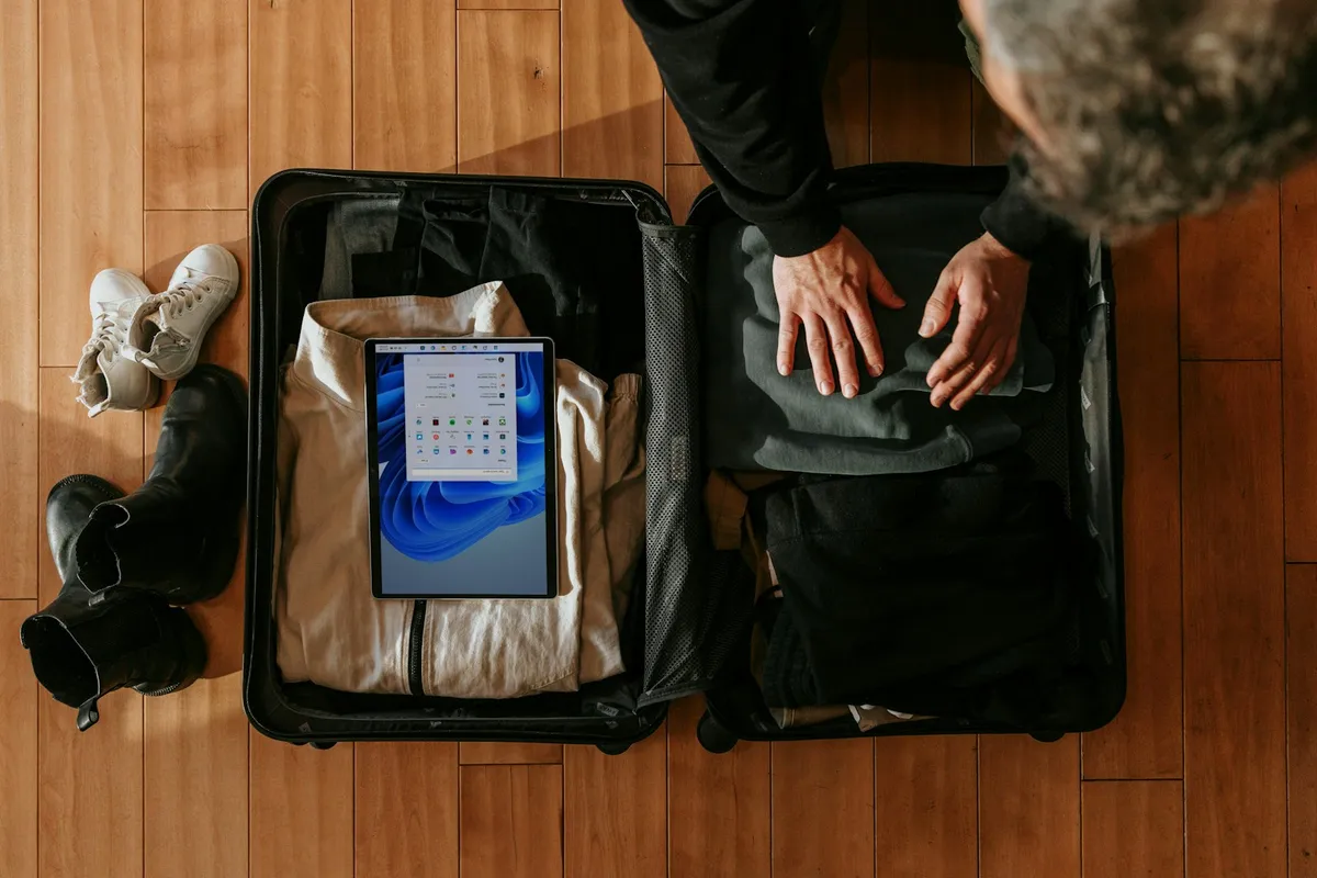 Traveler packing an open suitcase before completing South Korea customs checks
