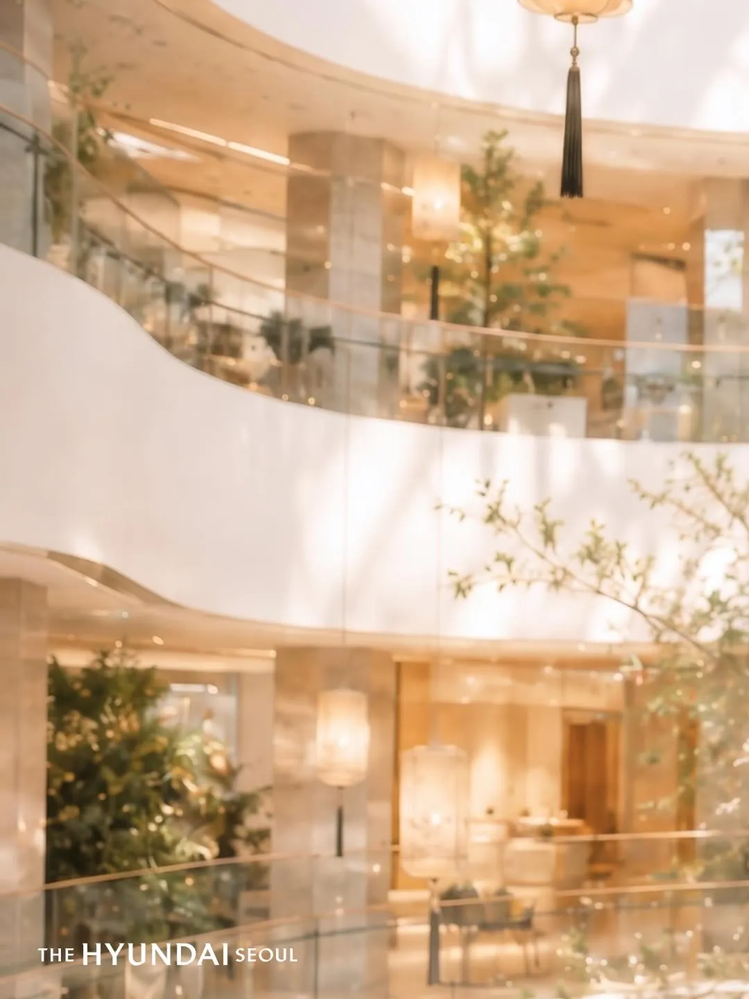 Bright indoor balcony and retail levels inside The Hyundai Seoul retail area