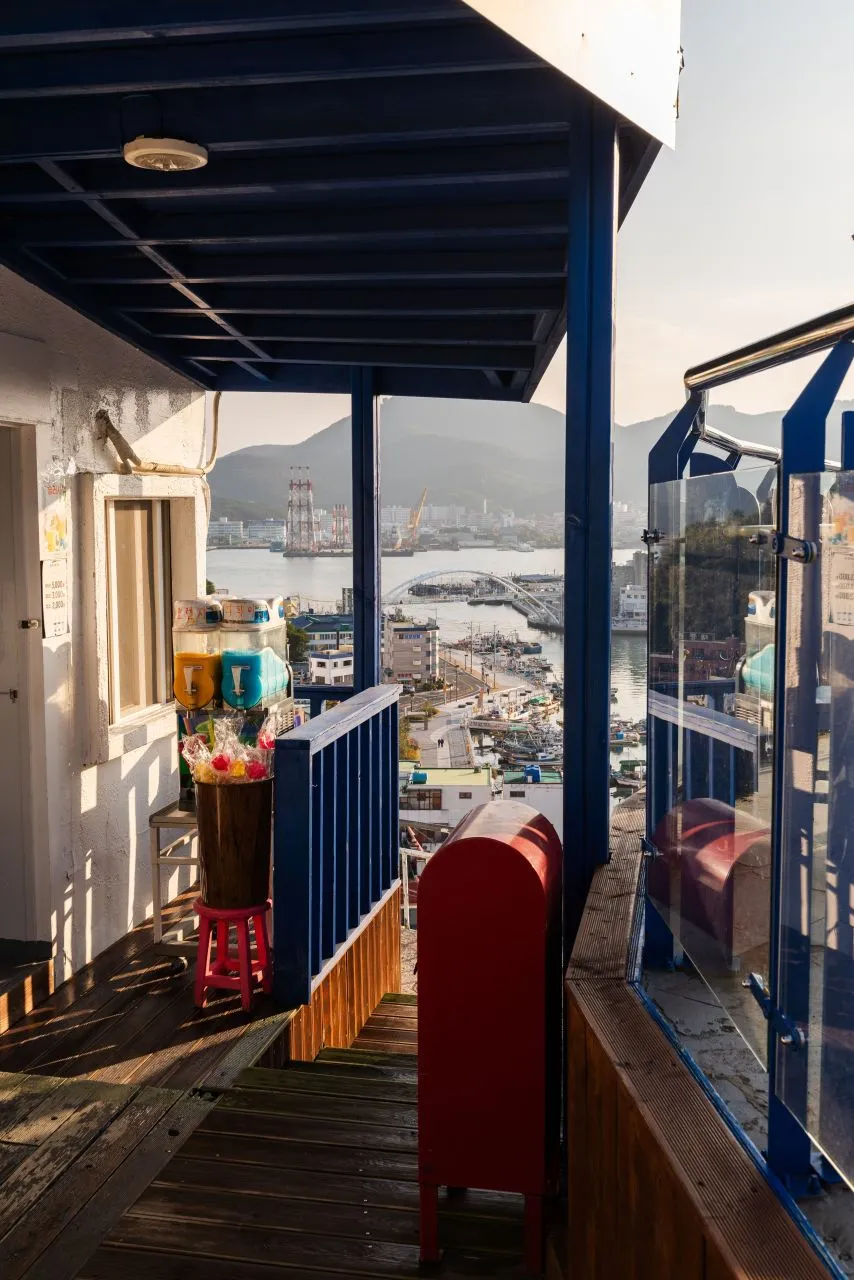 Narrow hillside passage overlooking Tongyeong harbor from Dongpirang Village