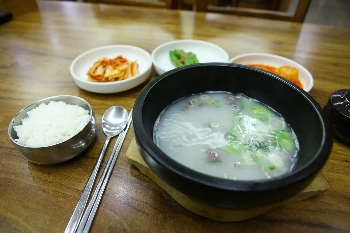 Gomtang beef soup with rice and banchan for a Korean soup guide