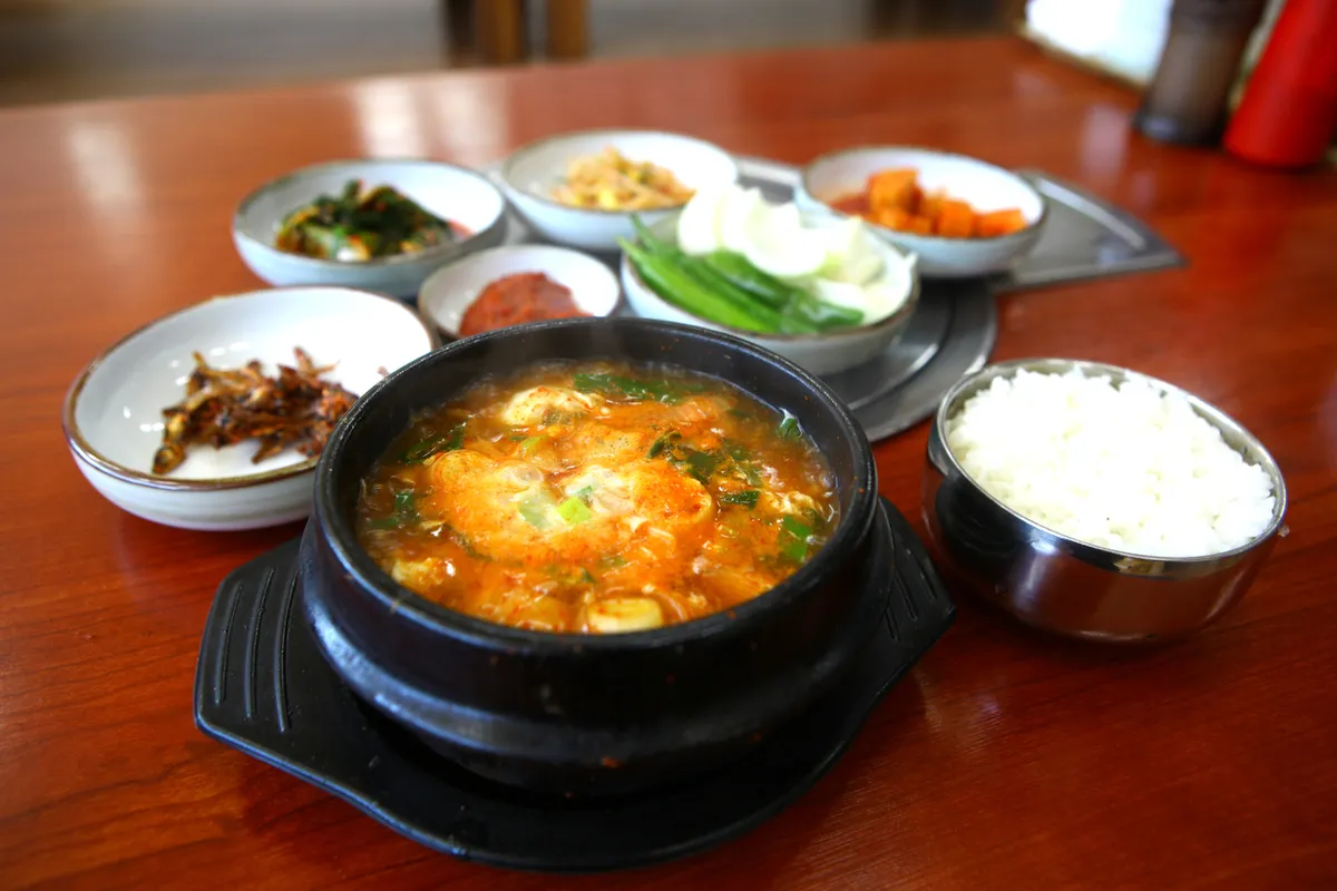 Sundubu jjigae soft tofu stew served with rice for a Korean soup guide