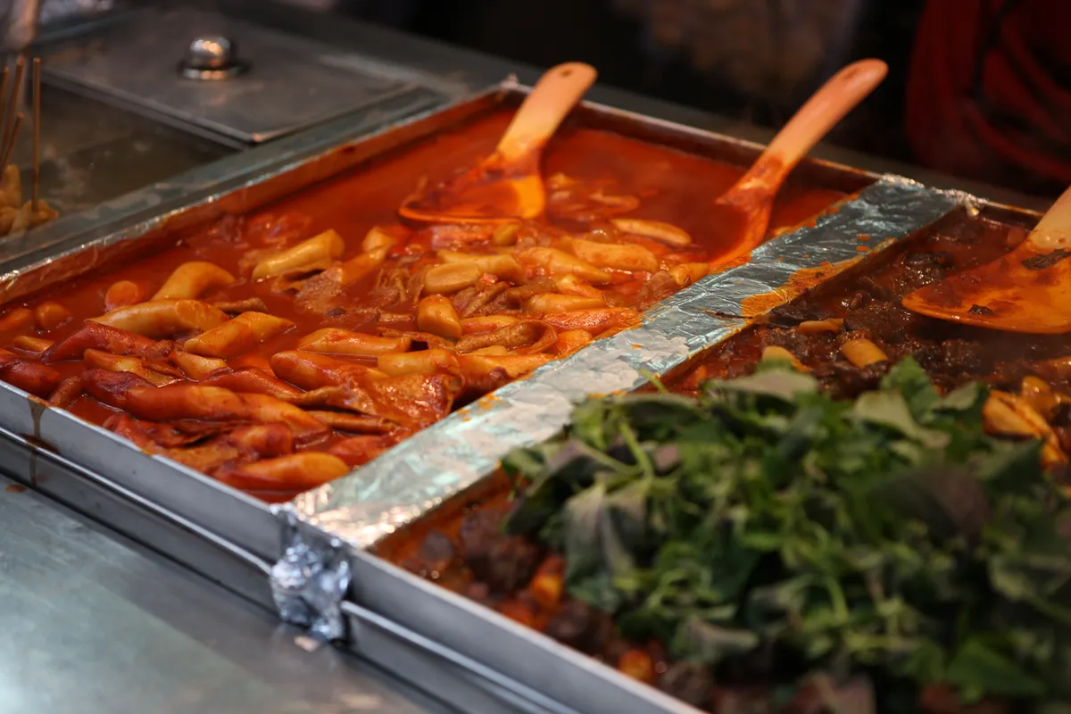 Large tray of red tteokbokki at a Seoul street-food stall