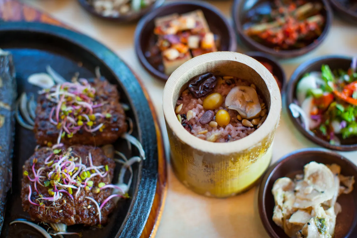 Tteokgalbi patties served with bamboo rice and grilled fish in Damyang