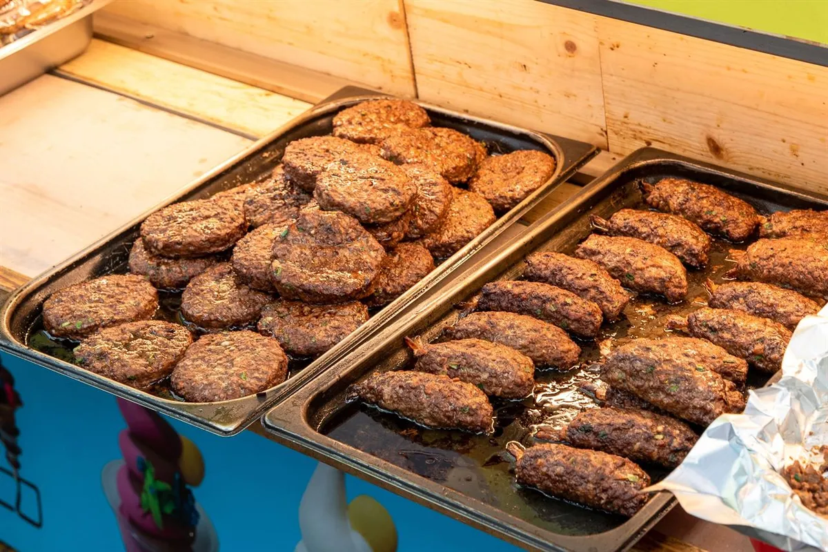 Rows of grilled tteokgalbi patties displayed at a Korean market stall