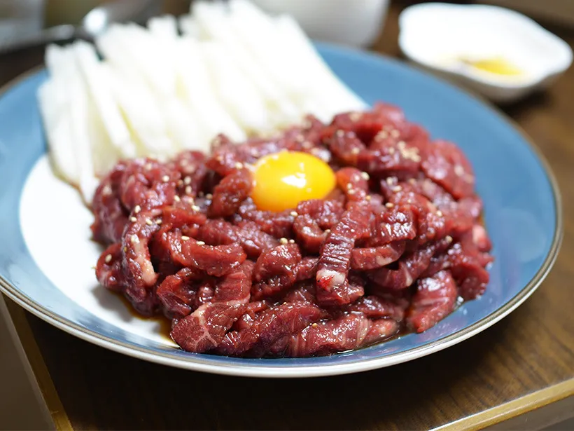 Yukhoe with raw egg yolk and sliced Korean pear